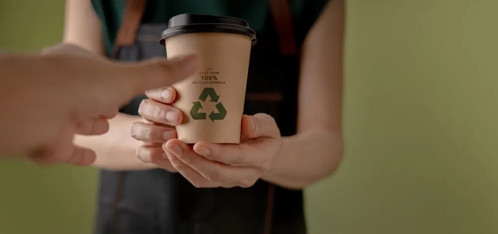 Eco-friendly paper coffee cup made from recycled packaging materials