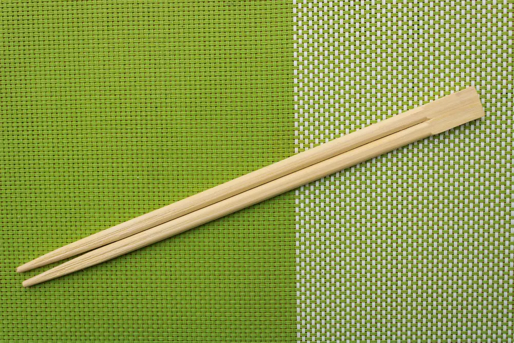Chopsticks for oriental or asian food on a green background.